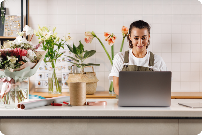Florist small business owner placing an order for stock on her laptop.