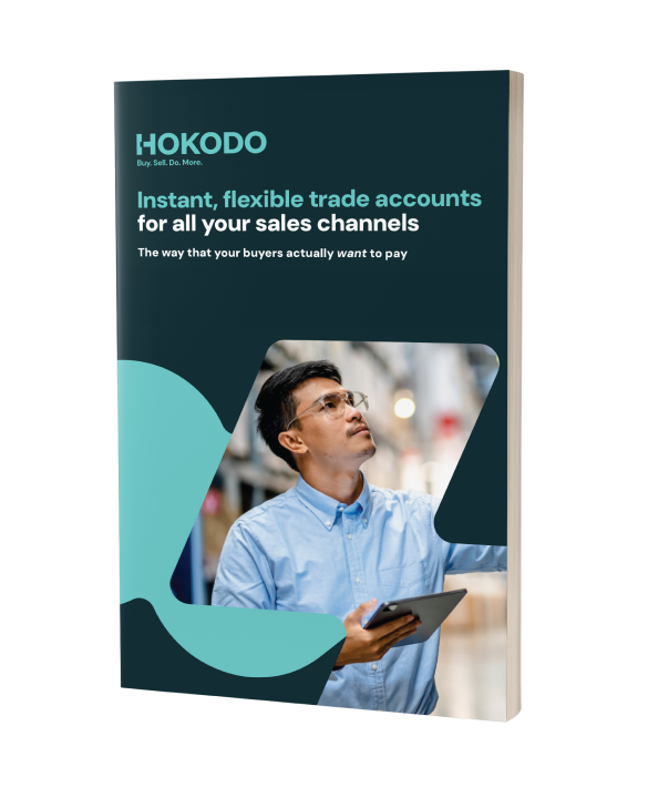 Brochure cover mockup featuring the title 'Instant, flexible trade accounts for all your sales channels: the way that your buyers actually want to pay'.