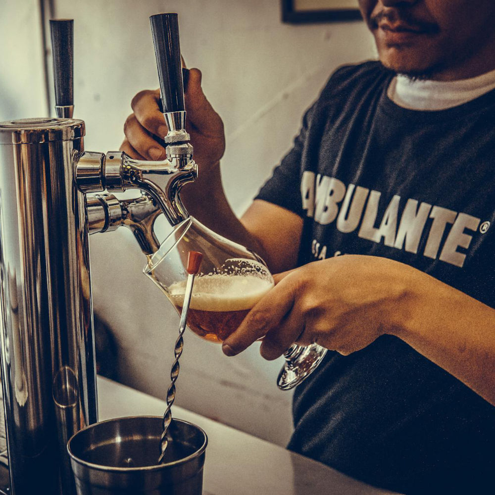 Bartender pouring draft beer into a glass